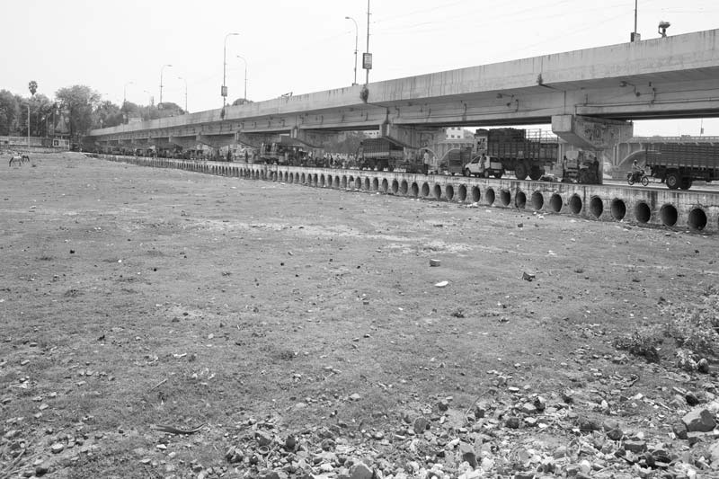 Challenges Impacting the Connection between Water and Religion - the dried-up bed of holy river Vaigai during the monsoon month of Aadi in Madurai, Tamil Nadu